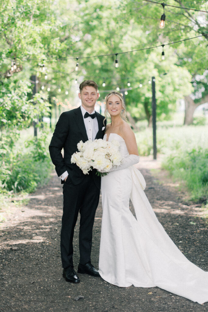 bride and groom smiling at the camera; Classic Wedding Photos at The Pines White Venue outside of Fargo, ND 