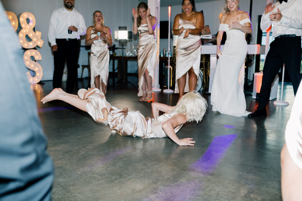 bridesmaid doing the worm on the dance floor