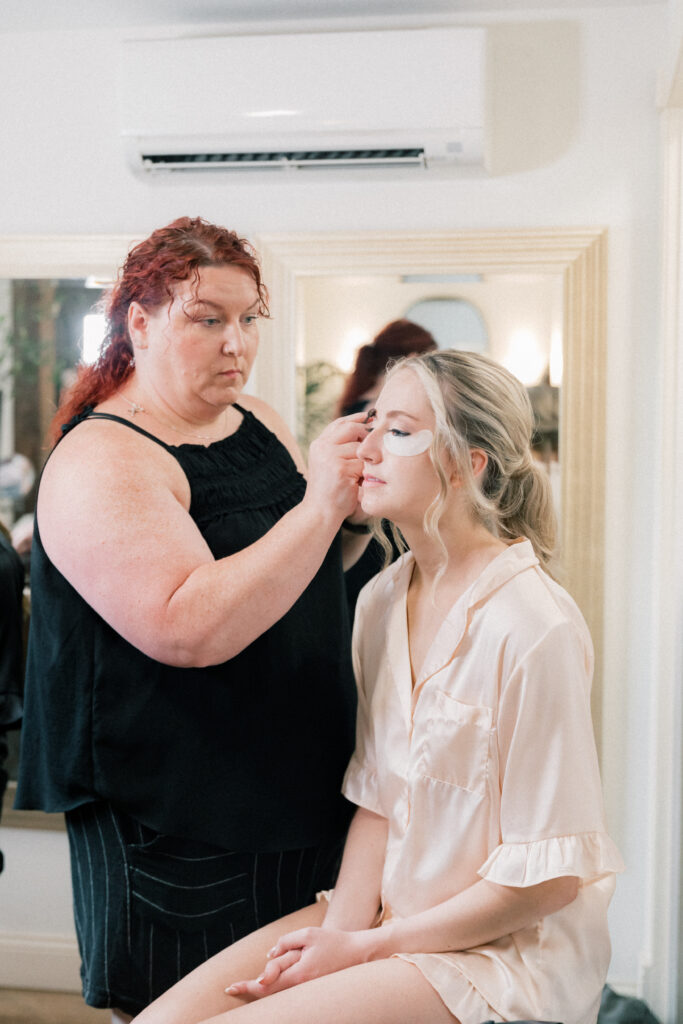 makeup artist doing bride's makeup