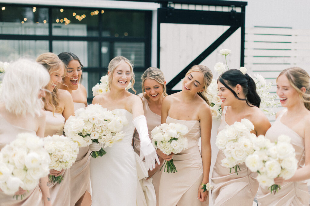 bride showing off her ring to her bridesmaids 