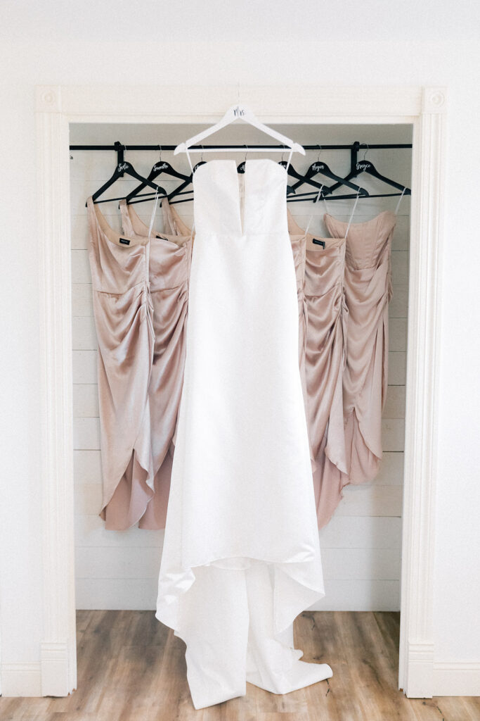 bride and bridesmaids dresses hung up