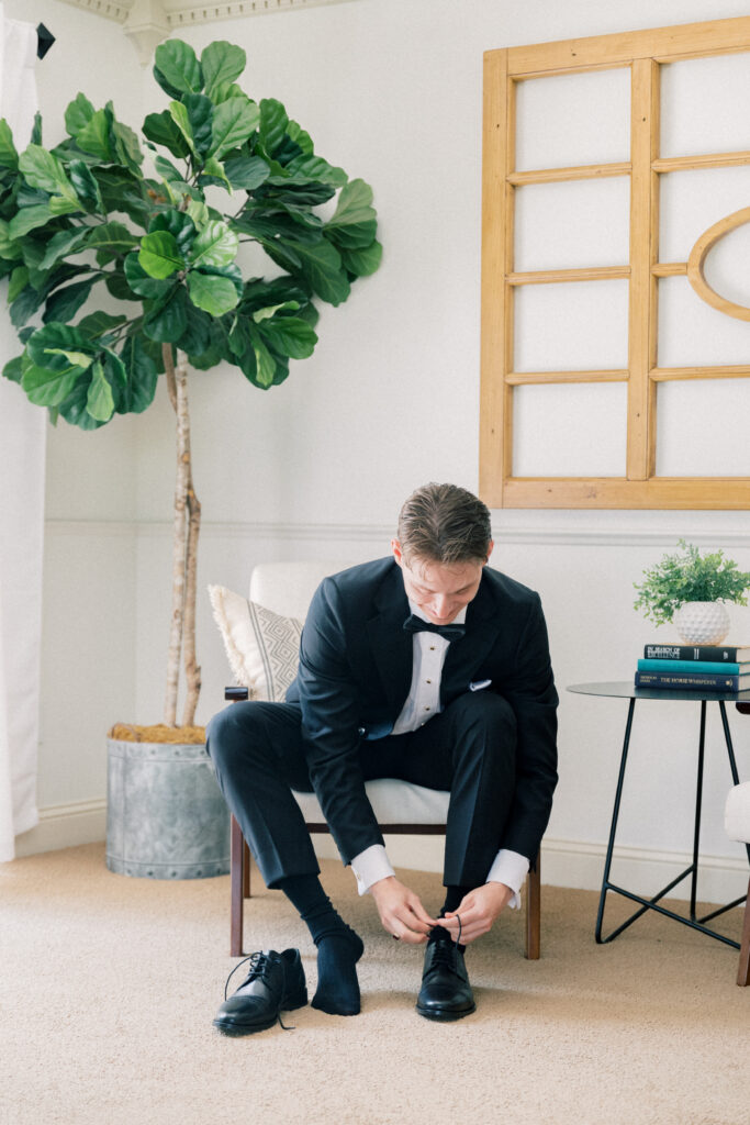 groom tying his shoes 