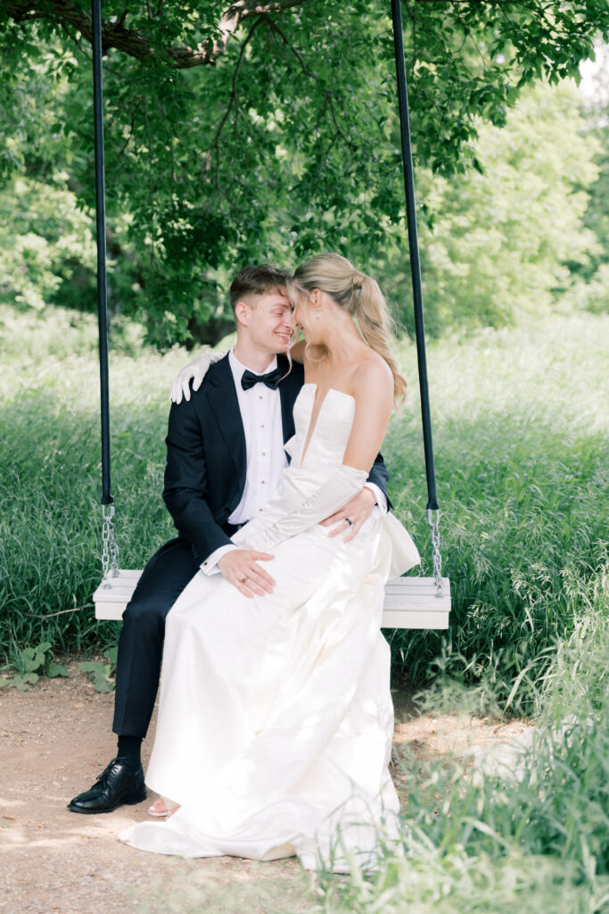 Bride and Groom on a swing; Classic Wedding Photos at The Pines White Venue outside of Fargo, ND 