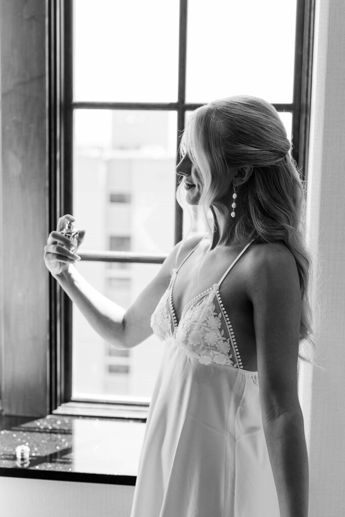 bride spraying on perfume