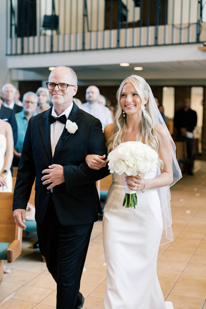 bride walking down the aisle with dad