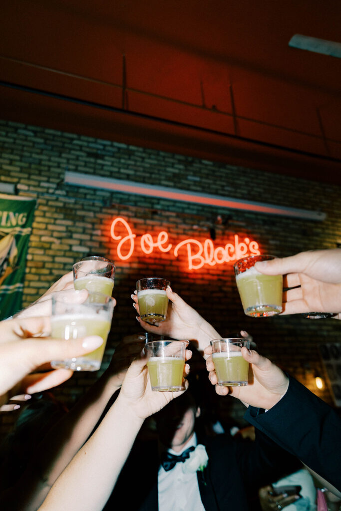 Bride and groom cocktail hour cheers 