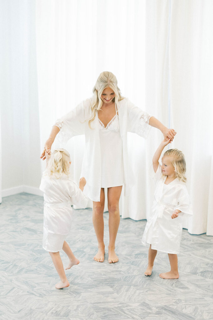 Bride and flower girls twirelling