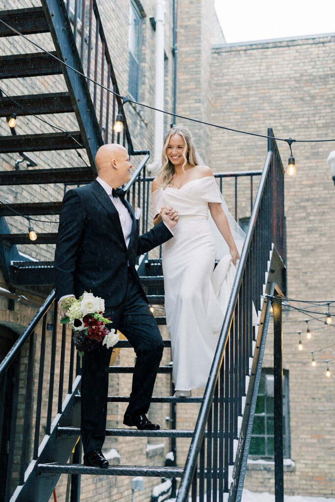 bride and groom outside portraits walking down steps