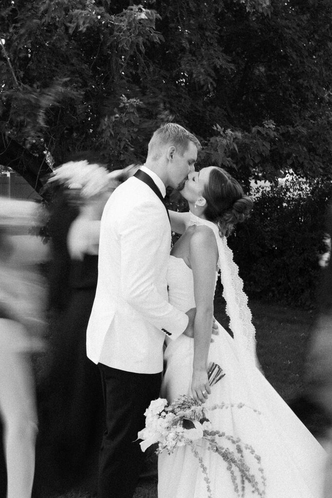 Blurred motion black and white image of the bride and groom kissing 