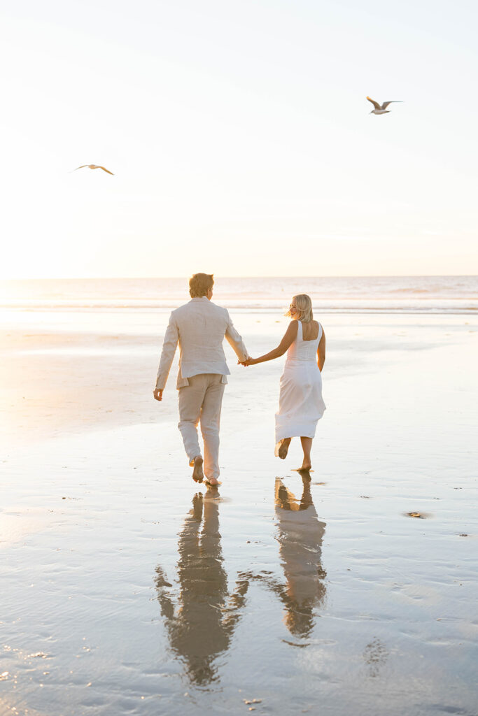 Bride and Groom walking on the beach at Scripps Seaside beach during an intimate elopement