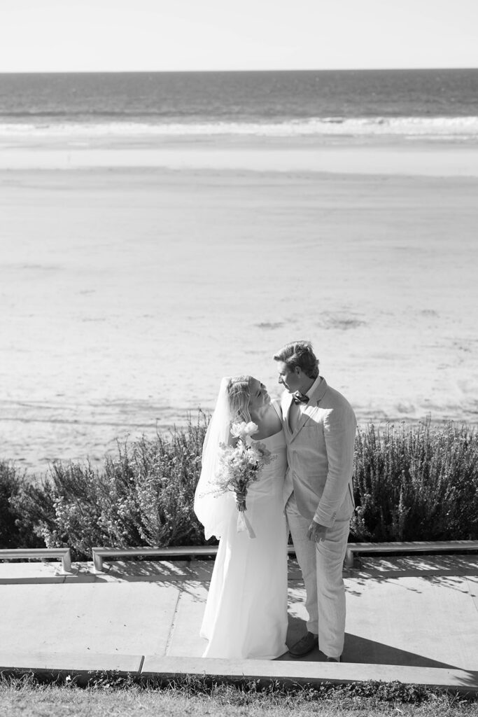 Couple smiling along the shoreline during a Scripps Seaside elopement