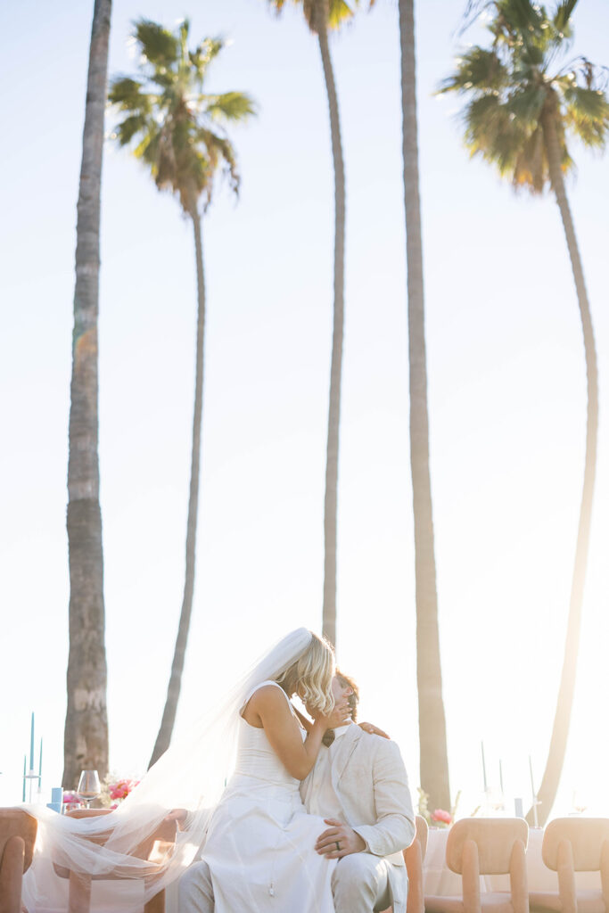 Bride and Groom kissing at a sunset view of Scripps Seaside beach during an intimate elopement