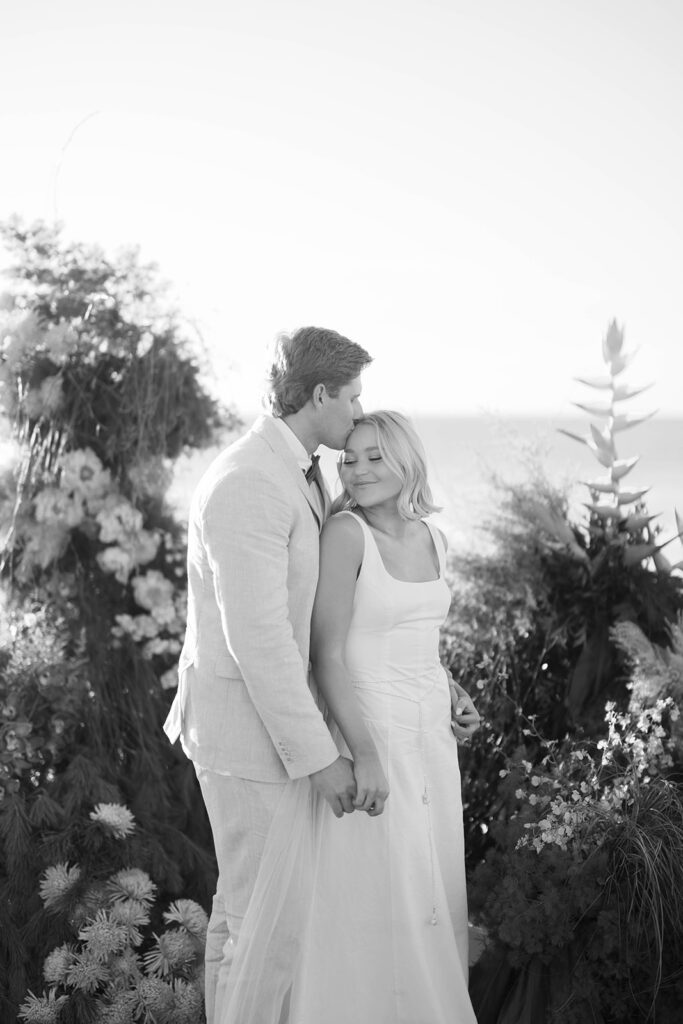 Bride and Groom kissing at a sunset view of Scripps Seaside beach during an intimate elopement