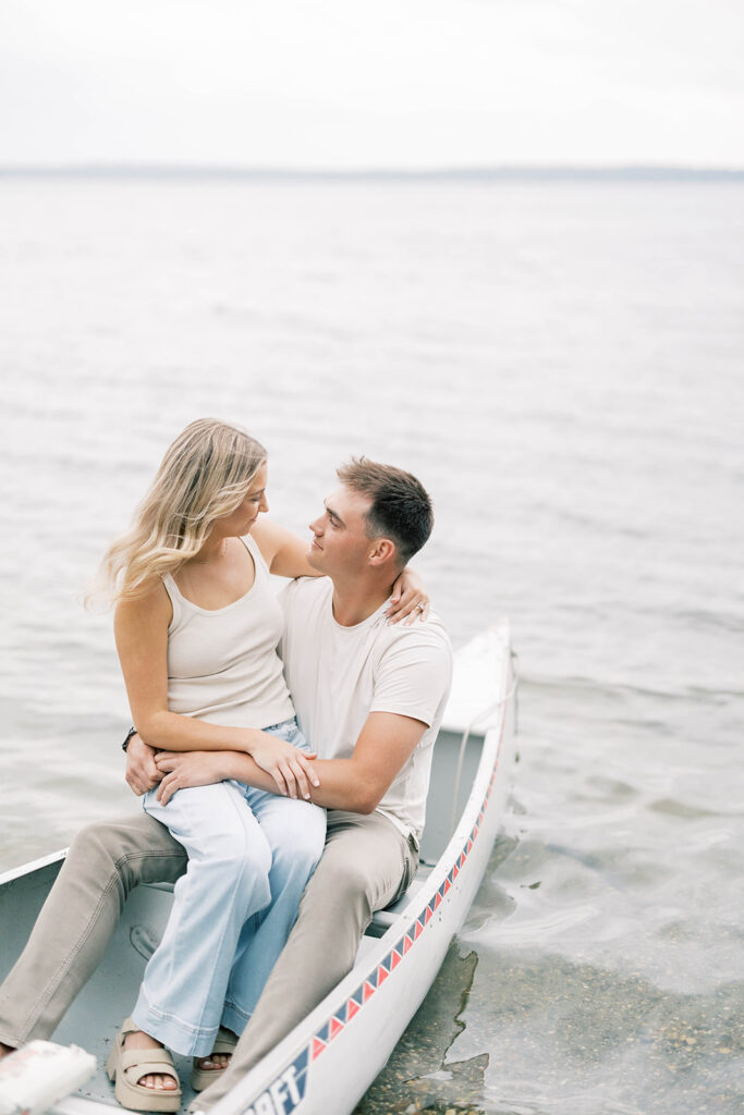 engagement session location idea, couple in a boat on a lake