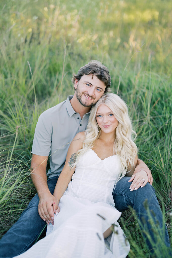 engagement session location idea, couple laying in the grass in nature