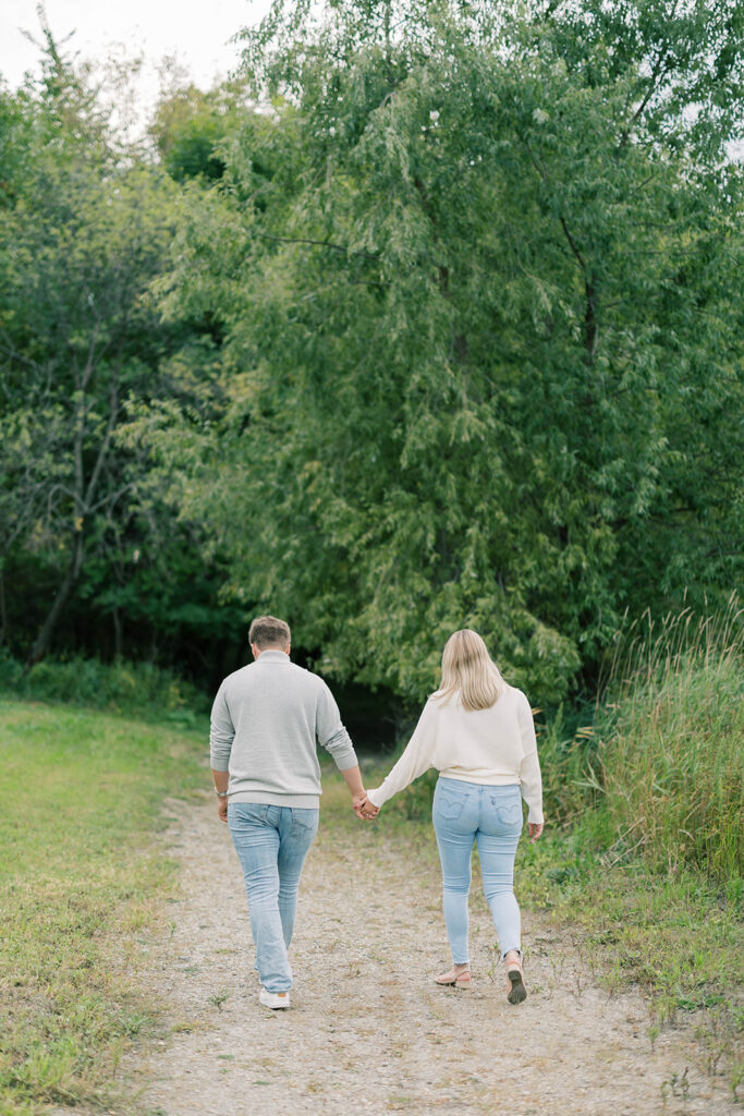engagement session location idea, couple walking down a path in a park