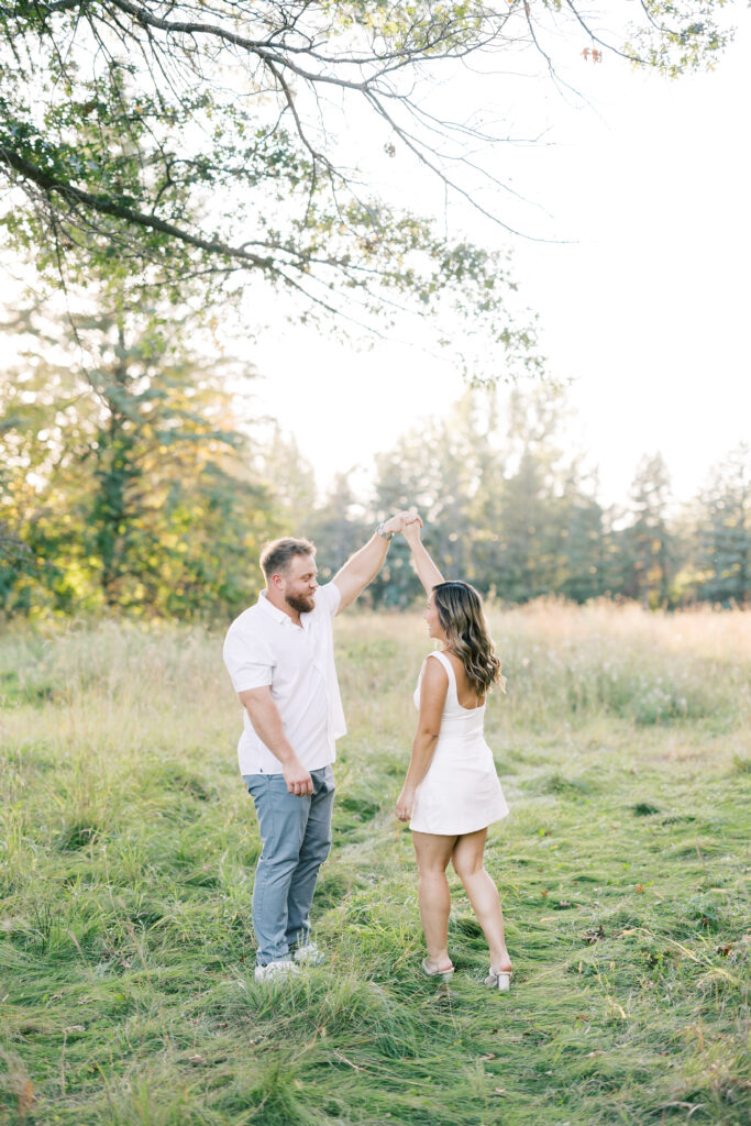 engagement session, a couple posing in a field surrounded by greenery