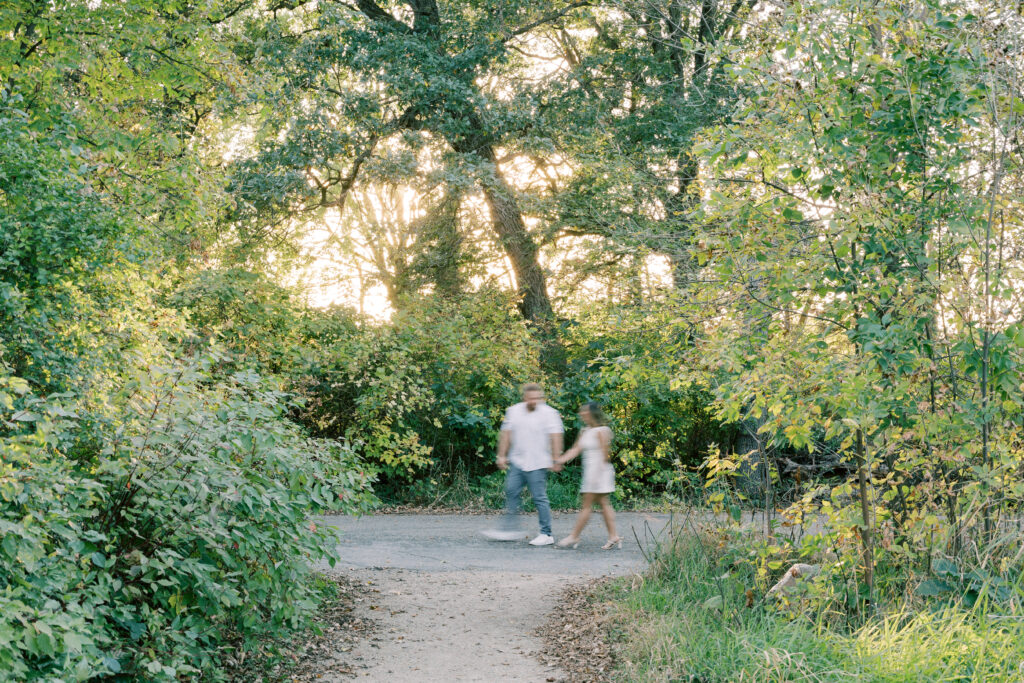 Engagement session, couple walking in a forrest
