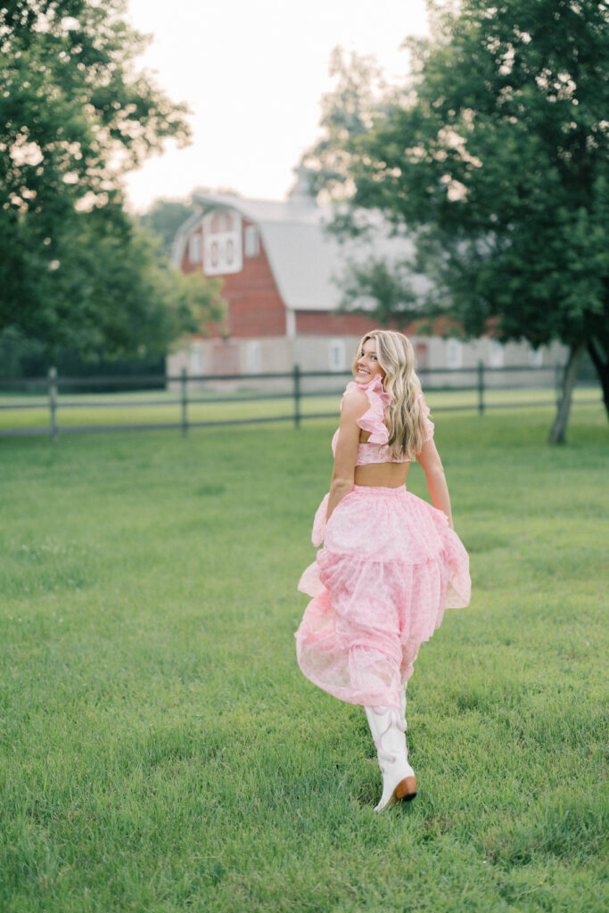 senior session, photo of a senior running in front of a barn
