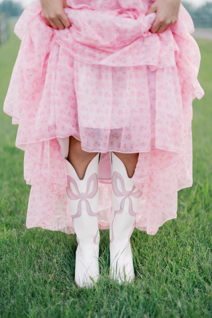 senior session, detailed photo of a pink dress and white boots with pink bows
