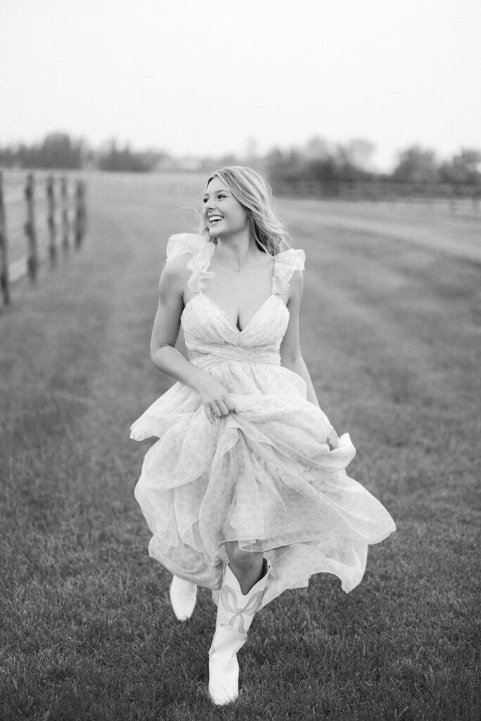 senior session, black and white photo of a senior running in nature