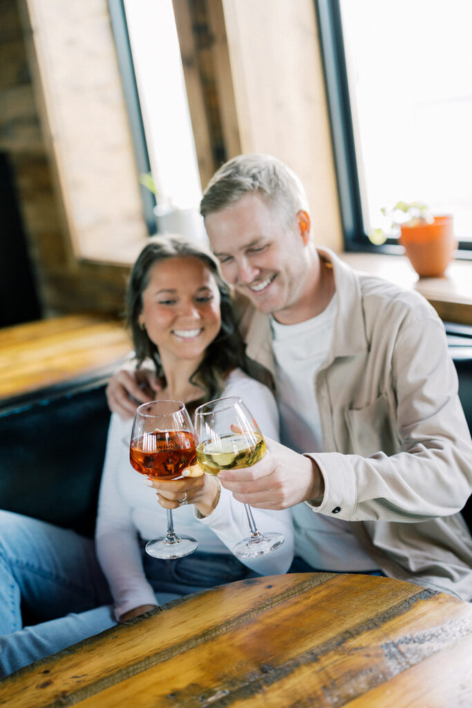 engagement session location idea, couple sitting at a table in a bar