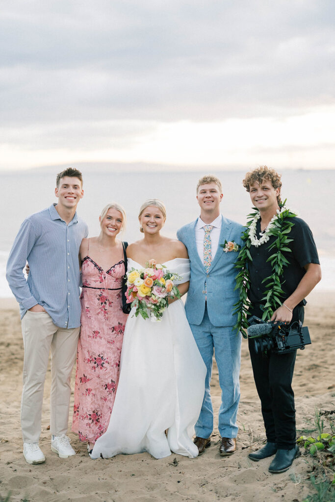 bride and groom with their photo and video team 