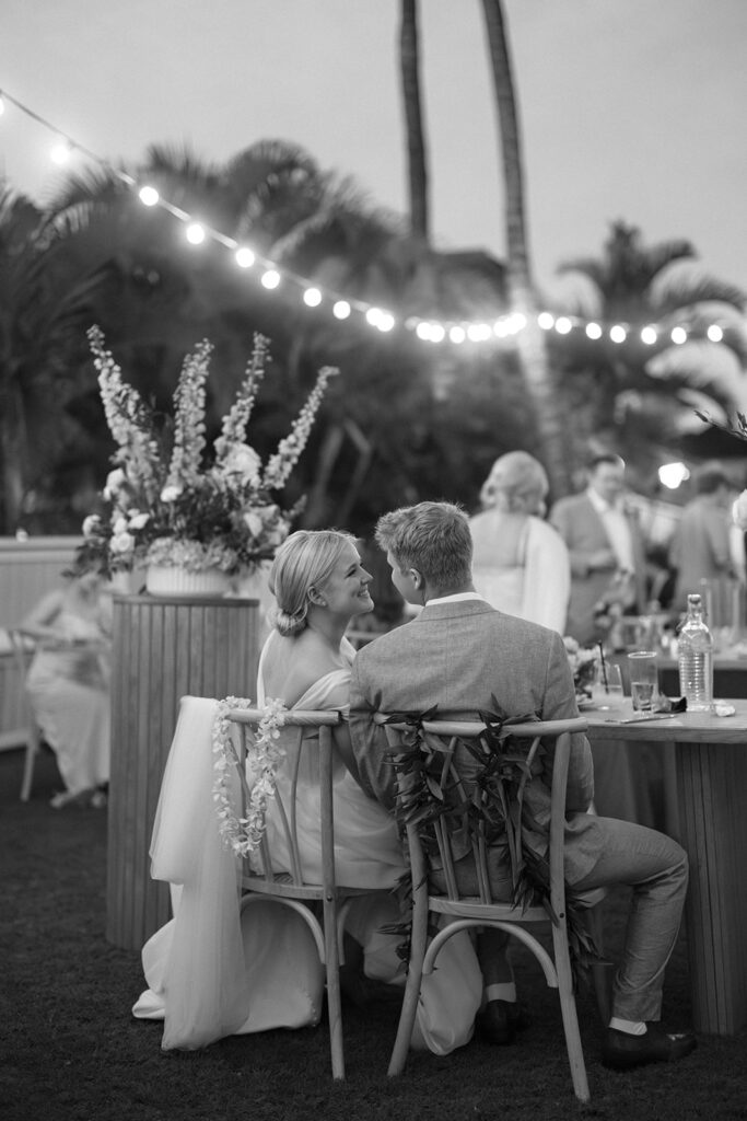 bride and groom smiling at each other during wedding reception dinner