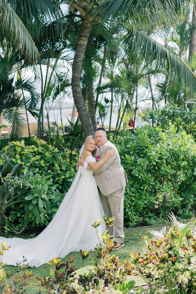 bride and father of the bride hugging