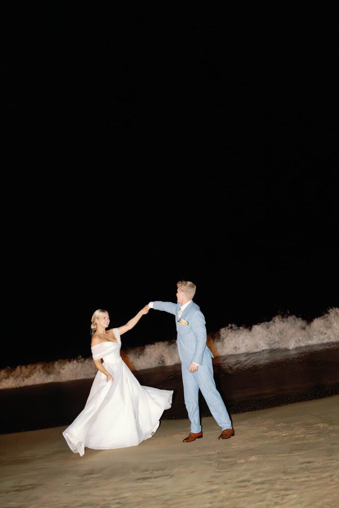 bride and groom dancing on the beach 
