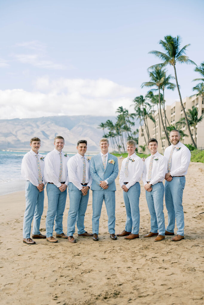 groom and groomsmen on the beach in hawaii, light blue suits