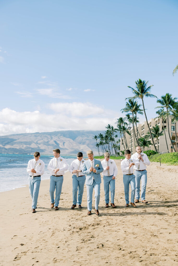 groom and groomsmen on the beach in hawaii, light blue suits