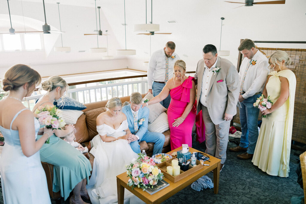 family praying together before the ceremony
