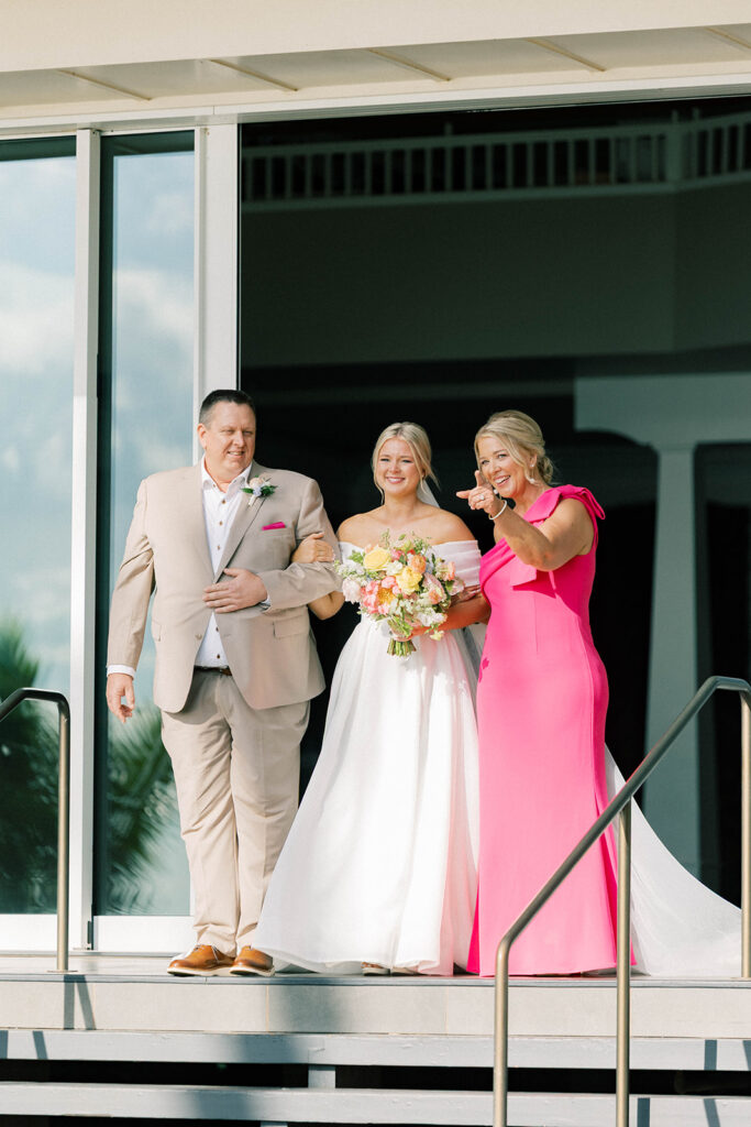 bride, mother and father walking down the aisle