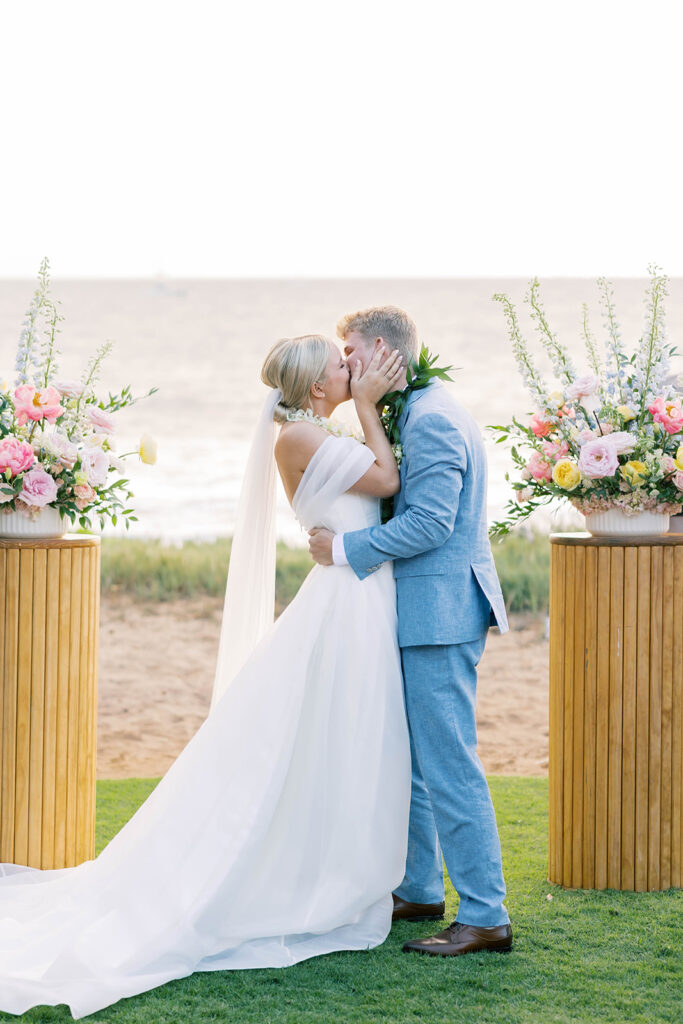 bride and groom at the ceremony alter, bride and groom kiss