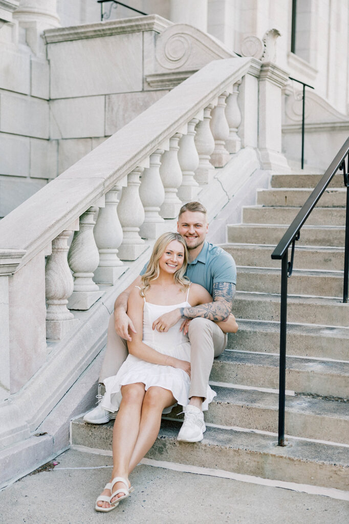 engagement session location idea, couple posing on stairs downtown