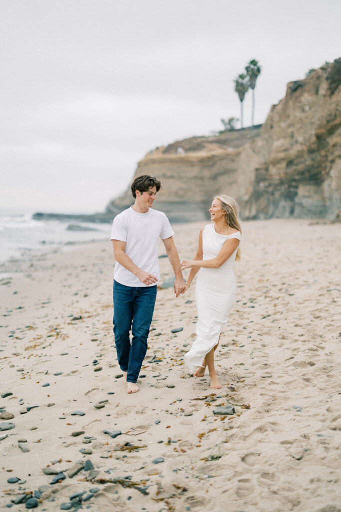 engagement session location idea, couple running on the beach