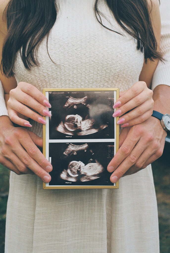 Maternity Session, couple holding up ultrasound photos