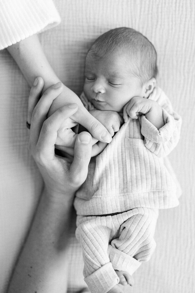 Maternity Session, black and white newborn laying on the bed 