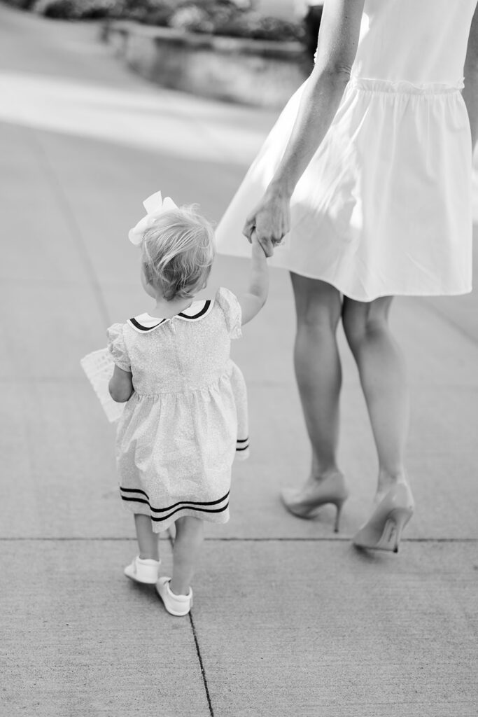 Maternity Session, black and white photo of a mother holding hands with her baby