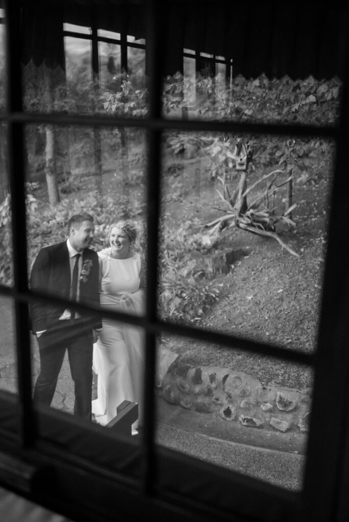 bride and groom portrait through window