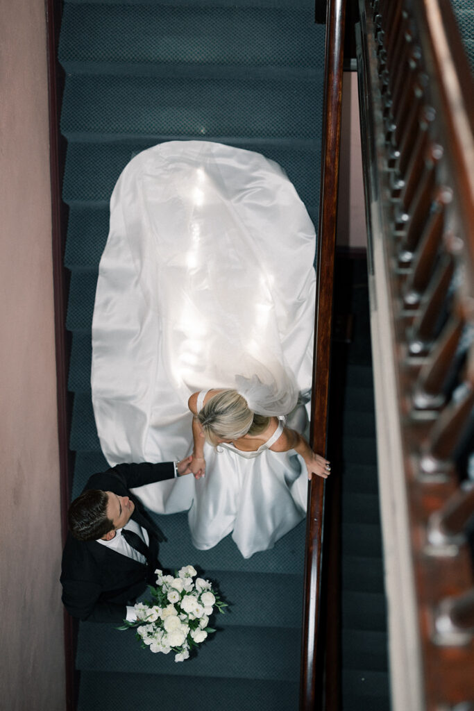 bride and groom walking down the stairs