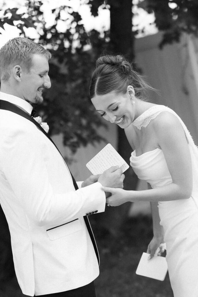 bride and groom reading their vows