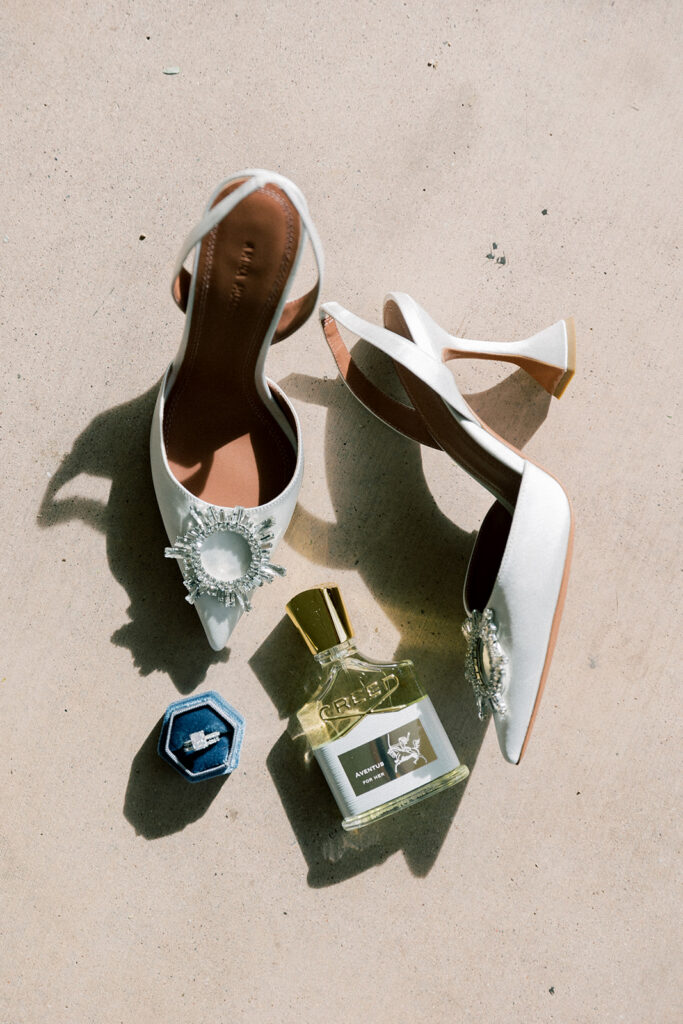 Shoes, jewelry, and perfume detail shot