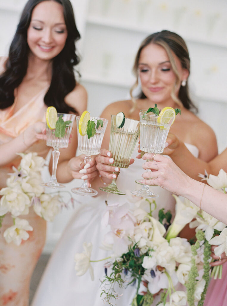 bride and bridesmaid cheers drinks