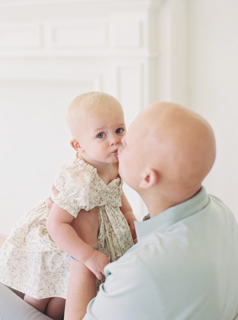 dad kissing baby girl