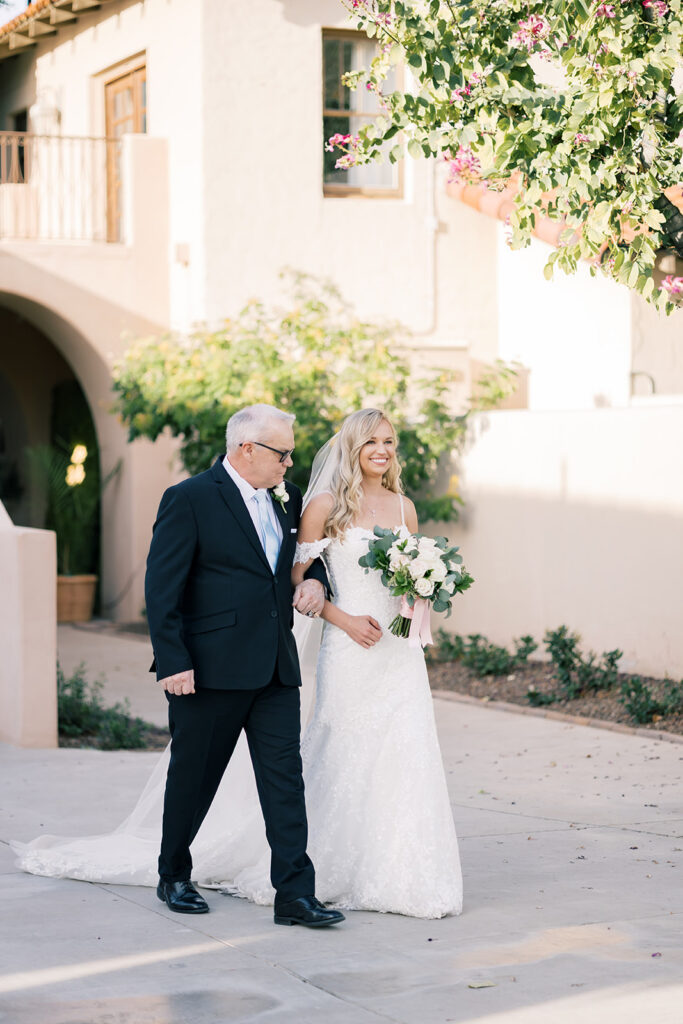 bride and dad walking down the isle 