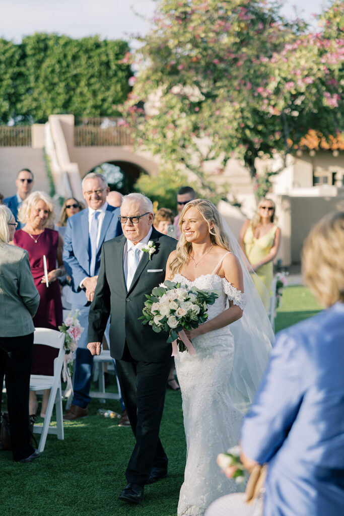bride and dad walking down the isle 